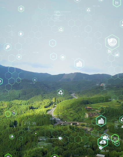 An aerial view of a lush green landscape overlaid with digital icons representing sustainability, energy efficiency and environmental data.