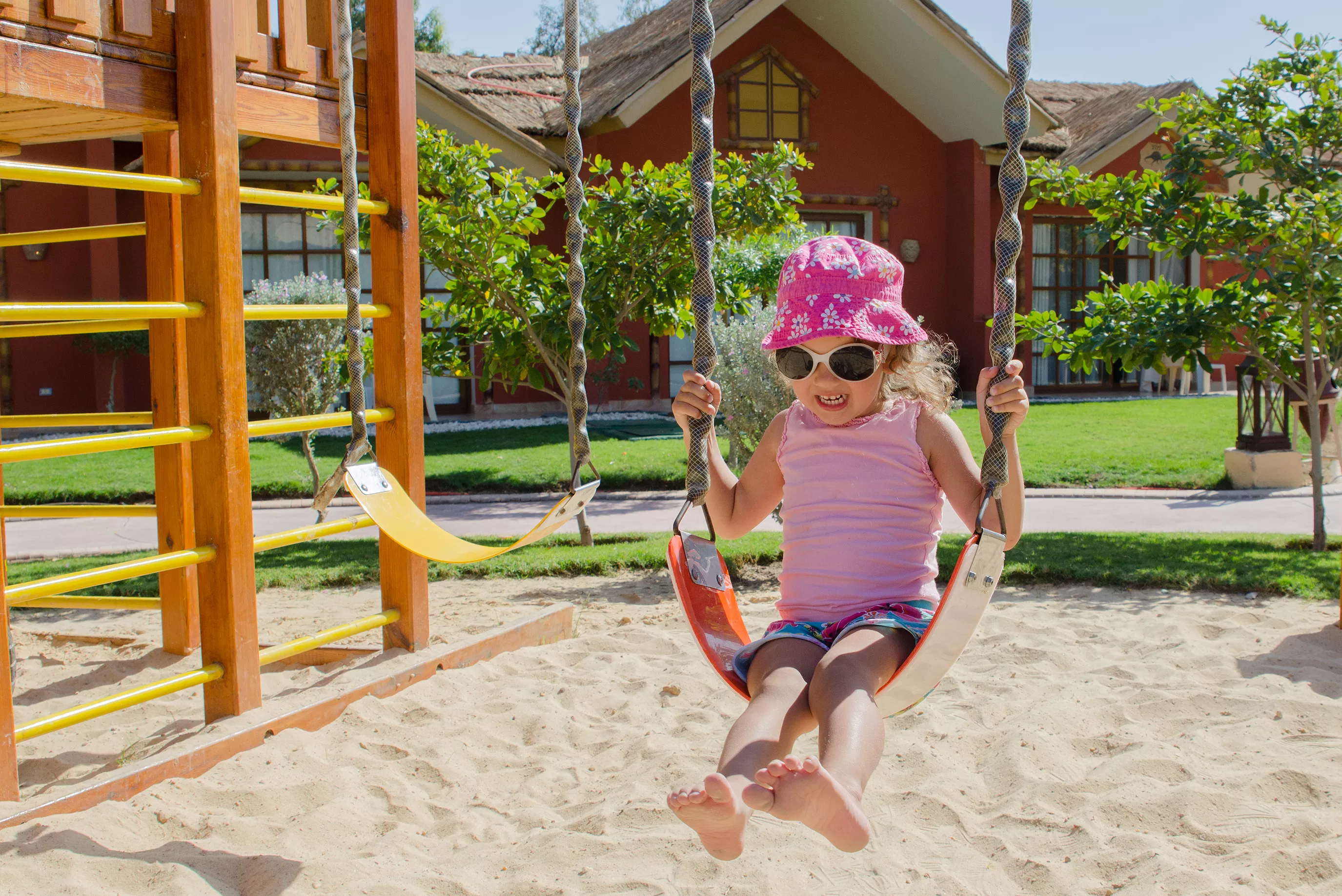 Little girl on swing in playground