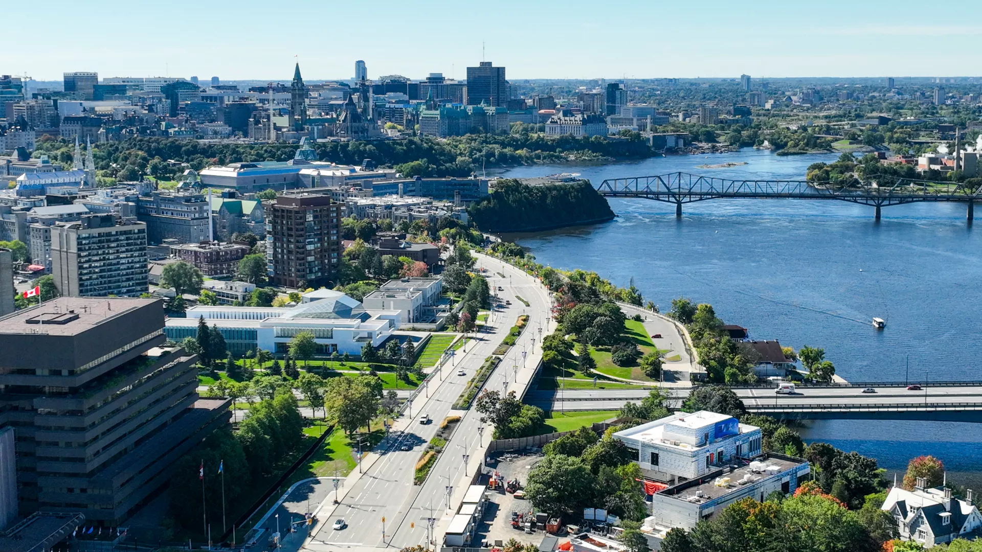 Aerial view of the Ottawa river, a street and downtown buildings. 