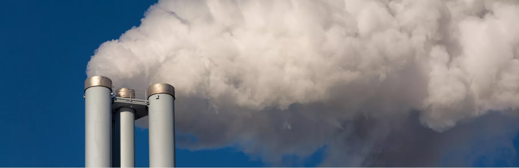 Factory exhaust pipes in sky with smoke 