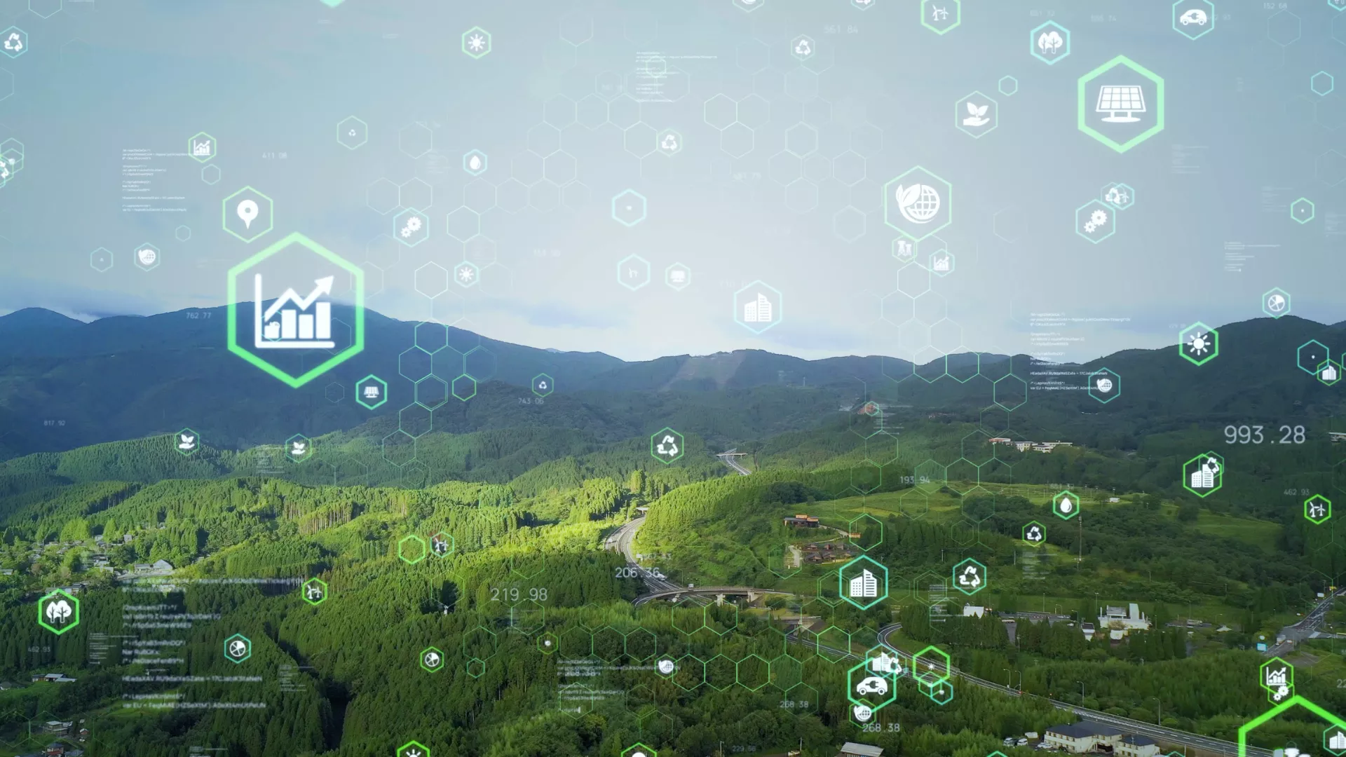 An aerial view of a lush green landscape overlaid with digital icons representing sustainability, energy efficiency and environmental data.